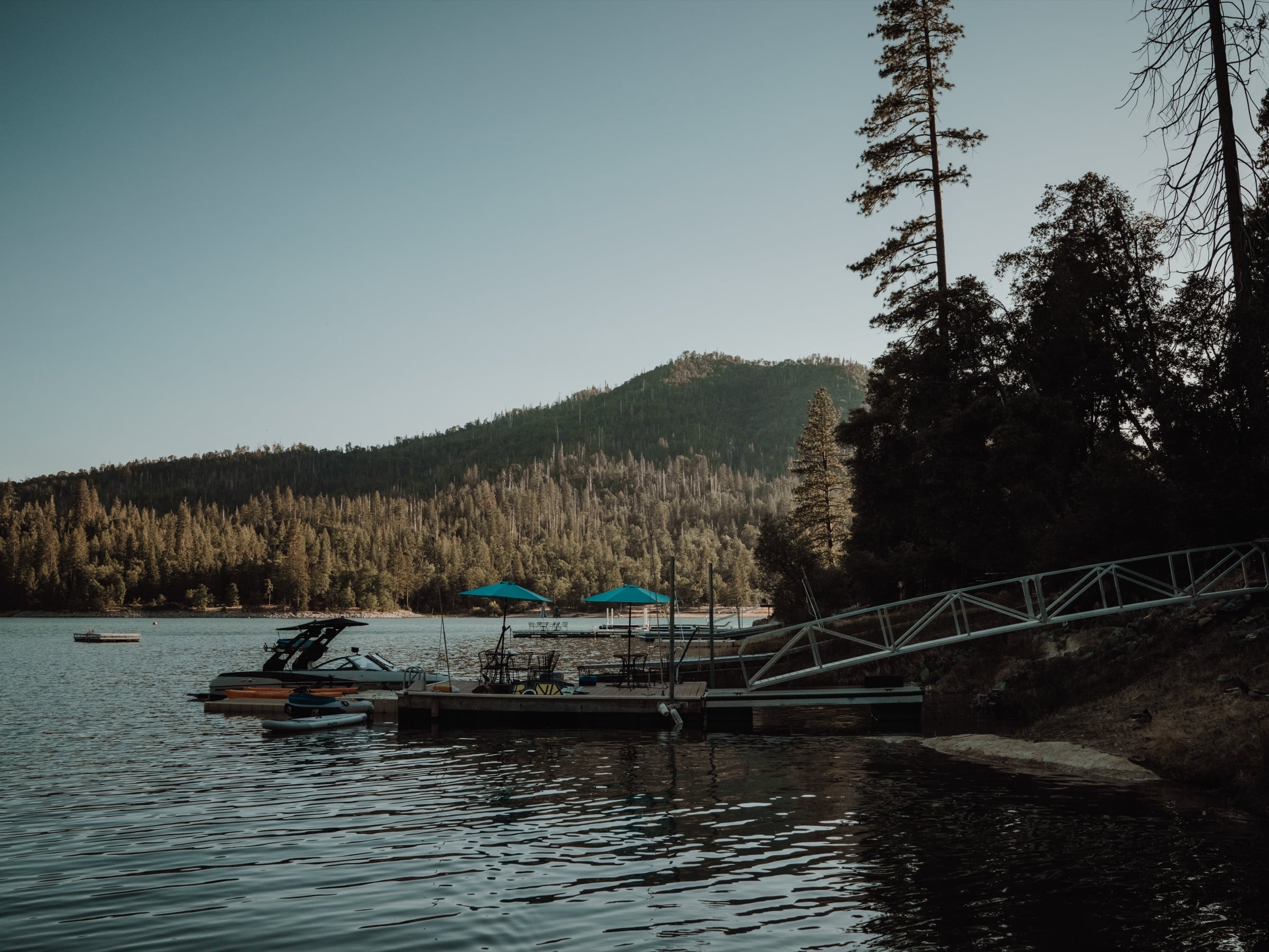 A small rocky island crowned with pines on a calm lake