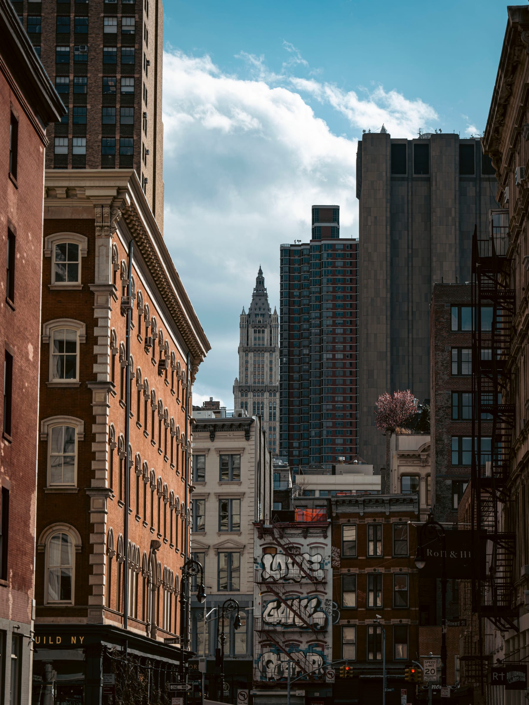 A downtown street canyon framing a distant gothic skyscraper