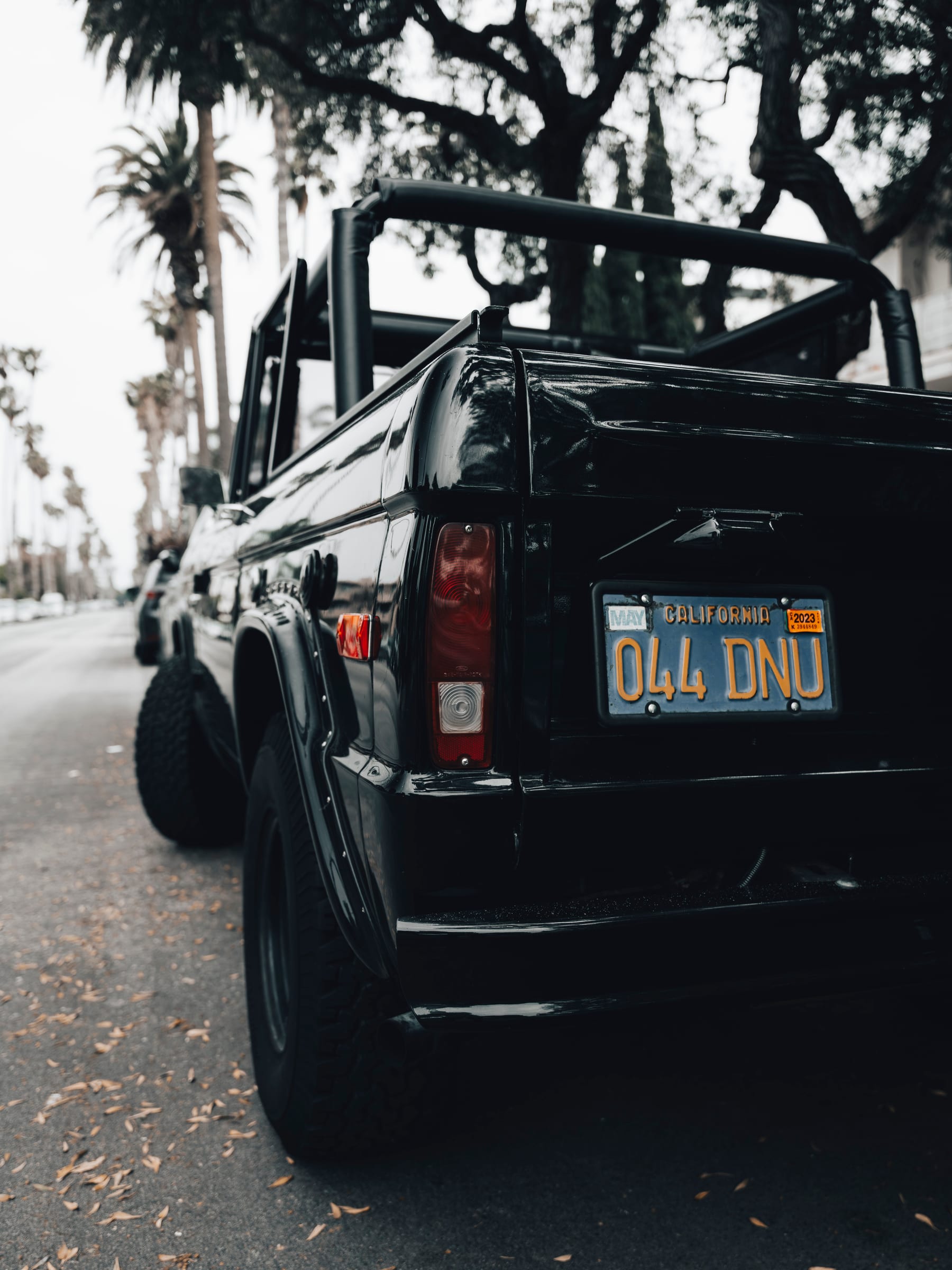 Rear detail of a black vintage Ford Bronco with a California plate