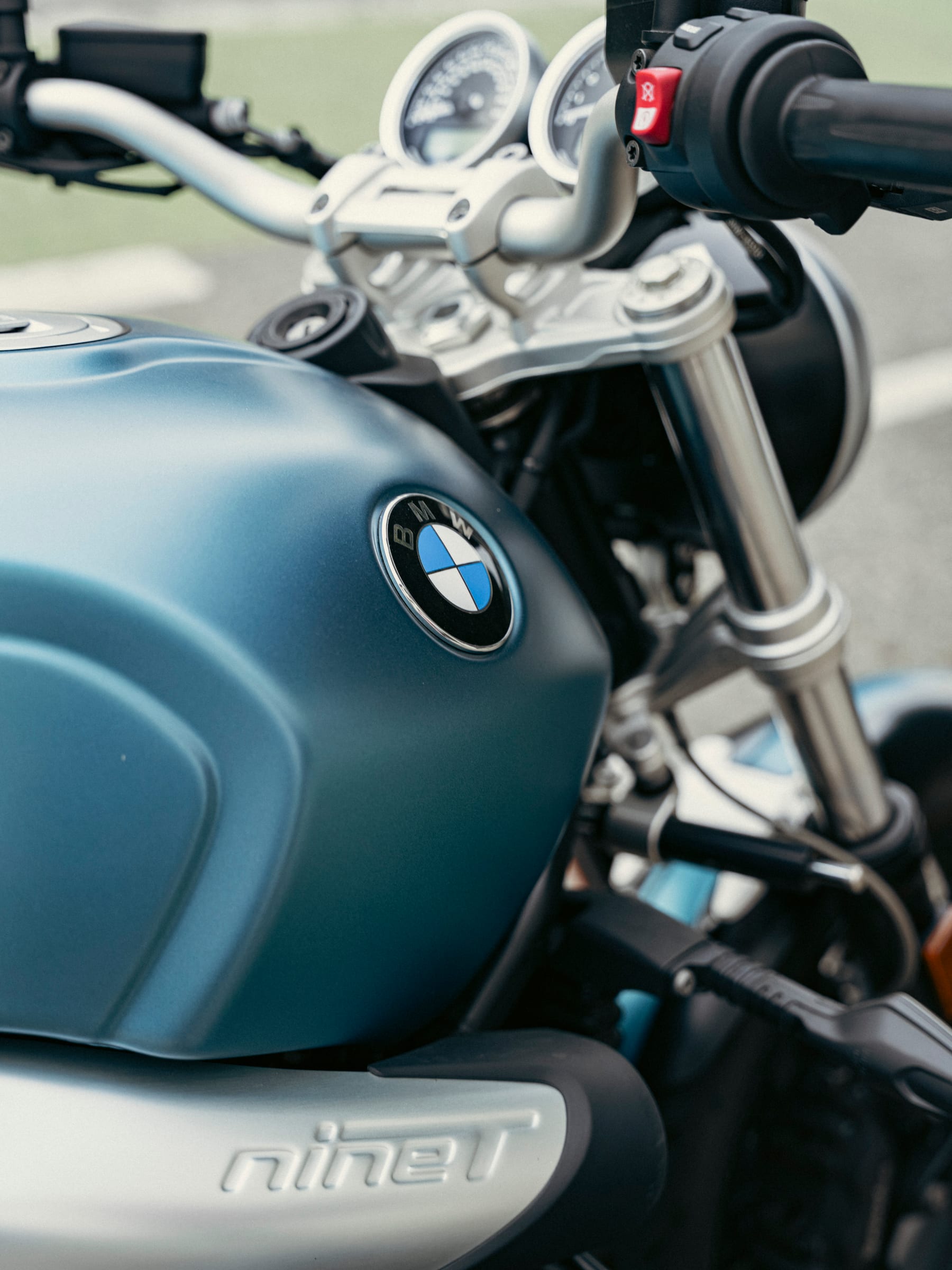 Detail of a BMW R nineT motorcycle tank and gauges in soft daylight