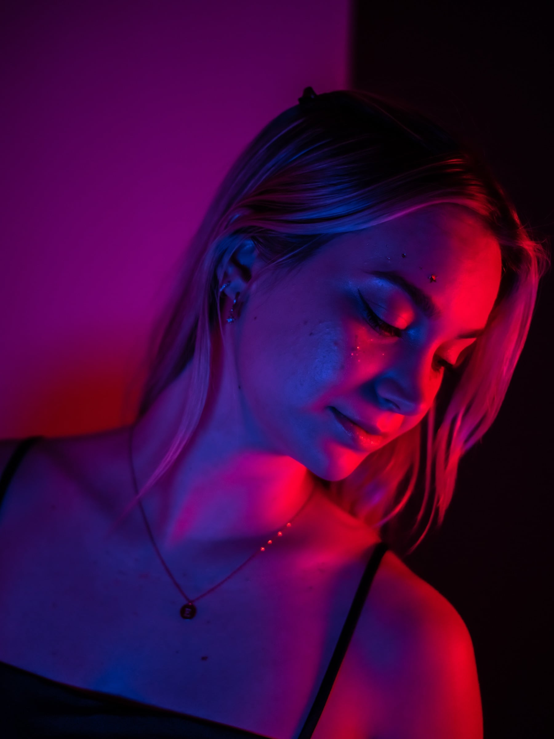 Editorial portrait bathed in bold colored gel lighting